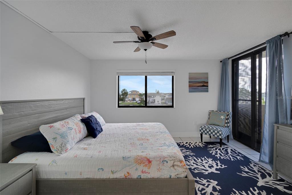 6035 Sea Ranch Drive, Unit 215 Hudson, FL 34667 - Photo 25 of 76 a bedroom with a large bed and a window