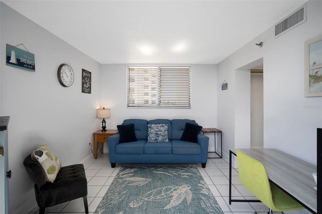 6035 Sea Ranch Drive, Unit 215 Hudson, FL 34667 - Photo 26 of 76 a living room with furniture and a window