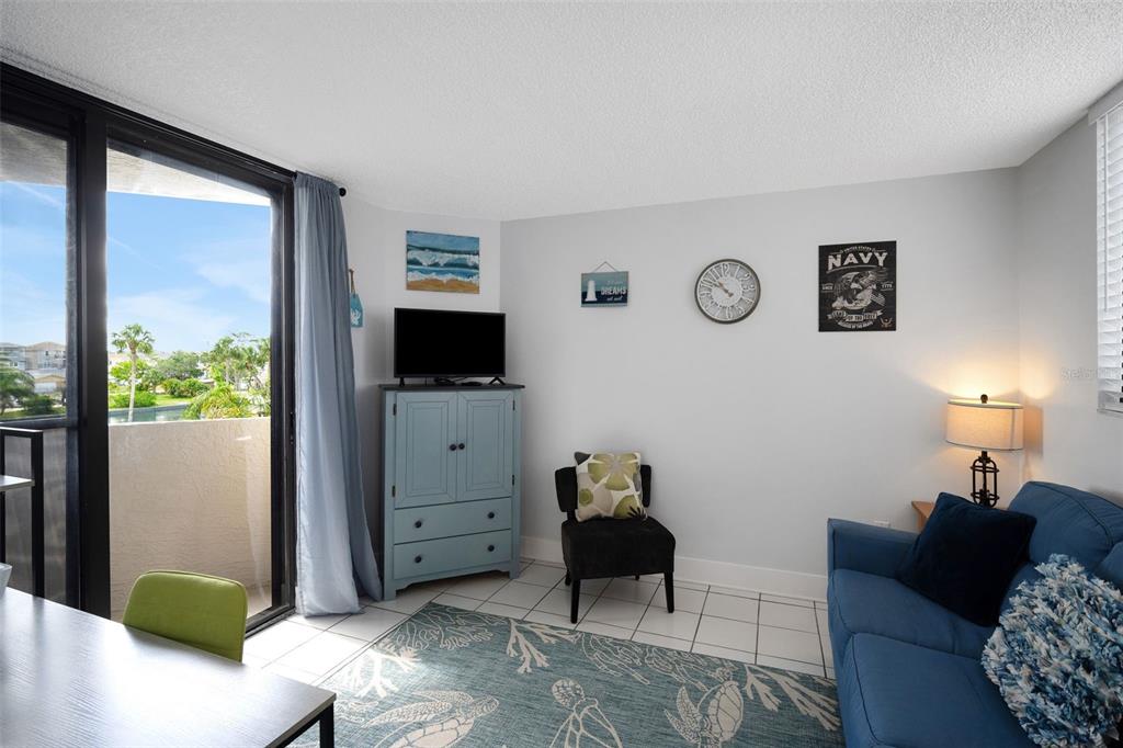 6035 Sea Ranch Drive, Unit 215 Hudson, FL 34667 - Photo 27 of 76 a living room with furniture and a flat screen tv