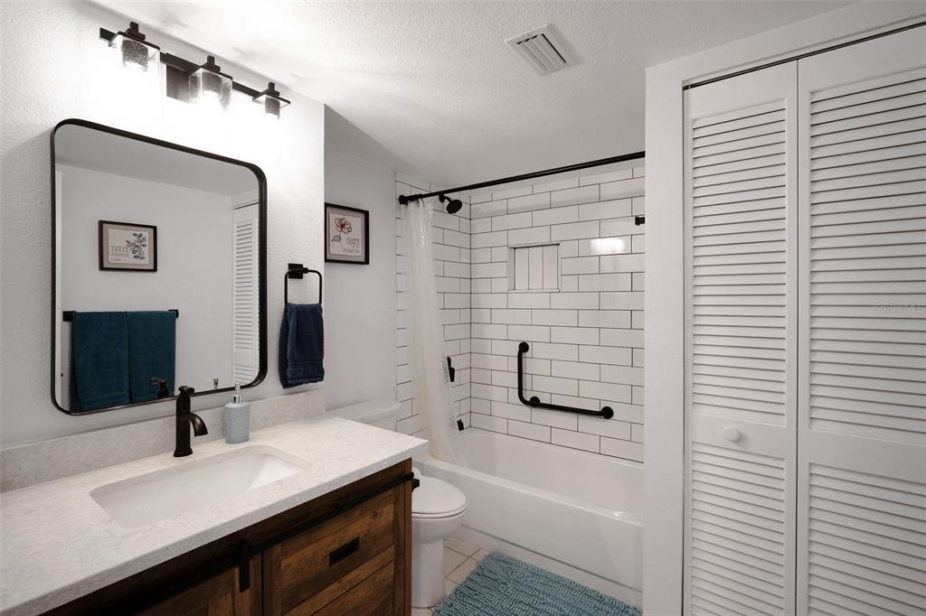 6035 Sea Ranch Drive, Unit 215 Hudson, FL 34667 - Photo 29 of 76 a bathroom with a sink a toilet and shower