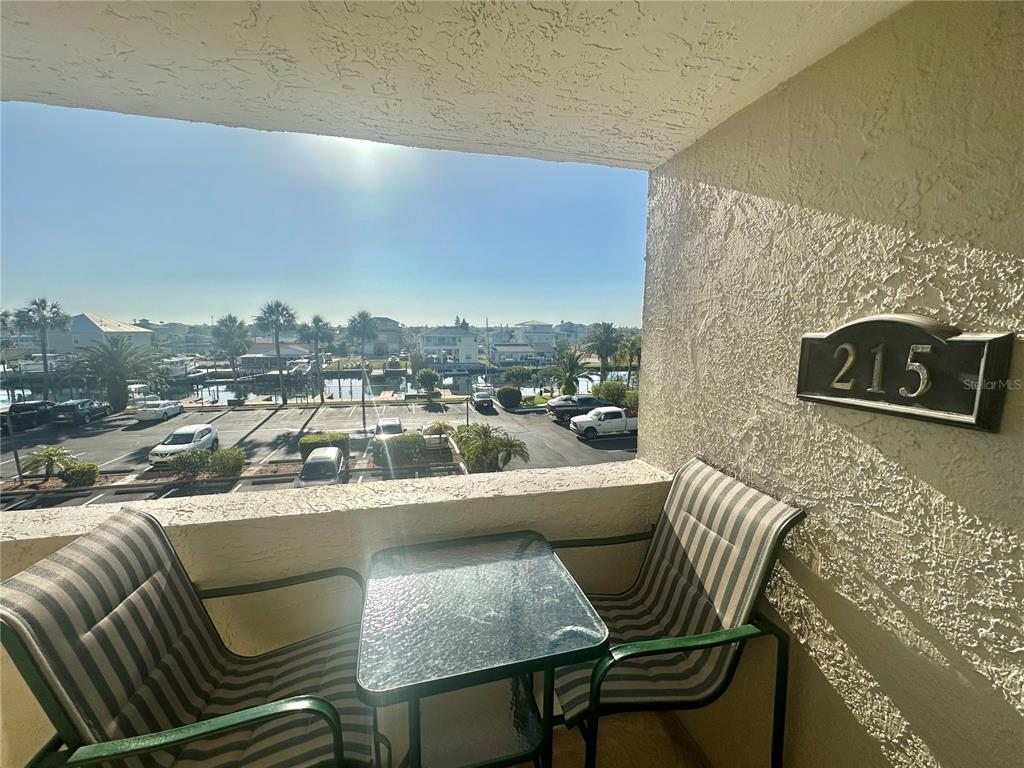 6035 Sea Ranch Drive, Unit 215 Hudson, FL 34667 - Photo 32 of 76 a view of a balcony with furniture and a fireplace