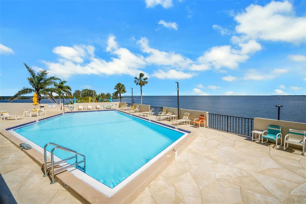 6035 Sea Ranch Drive, Unit 215 Hudson, FL 34667 - Photo 37 of 76 a view of a swimming pool with a lounge chairs