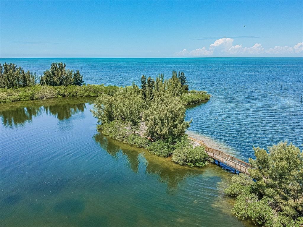 6035 Sea Ranch Drive, Unit 215 Hudson, FL 34667 - Photo 47 of 76 a view of a lake with a yard