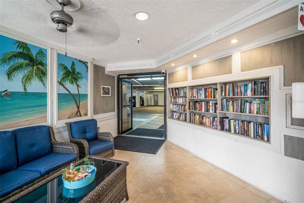 6035 Sea Ranch Drive, Unit 215 Hudson, FL 34667 - Photo 51 of 76 a living room with furniture and a book shelf