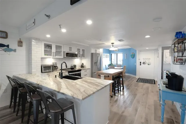 a kitchen with a sink stove and microwave