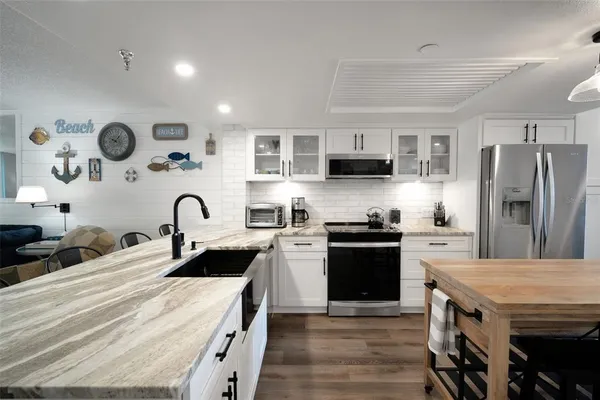 a kitchen with refrigerator and cabinets