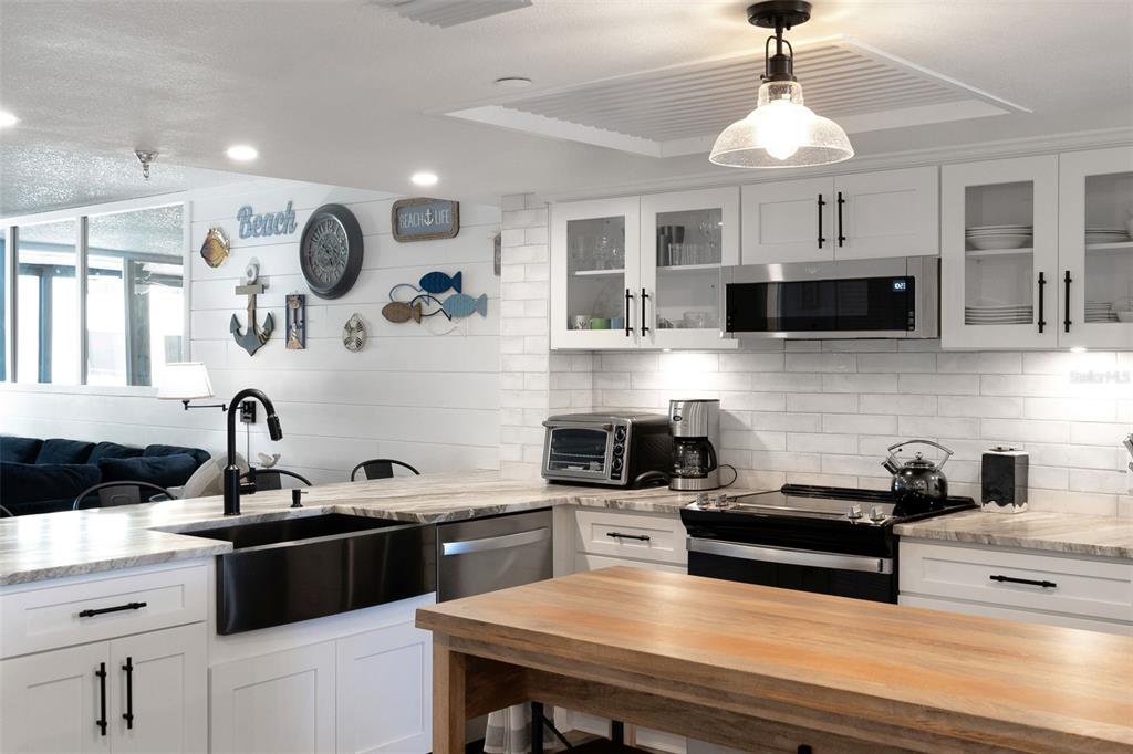 6035 Sea Ranch Drive, Unit 215 Hudson, FL 34667 - Photo 8 of 76 a kitchen with a sink stove and microwave