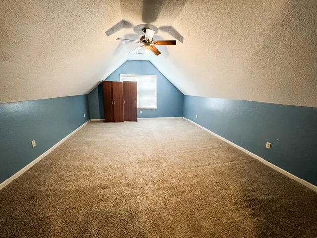 a view of empty room with a ceiling fan