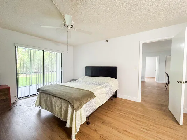 a bedroom with a bed and a large window