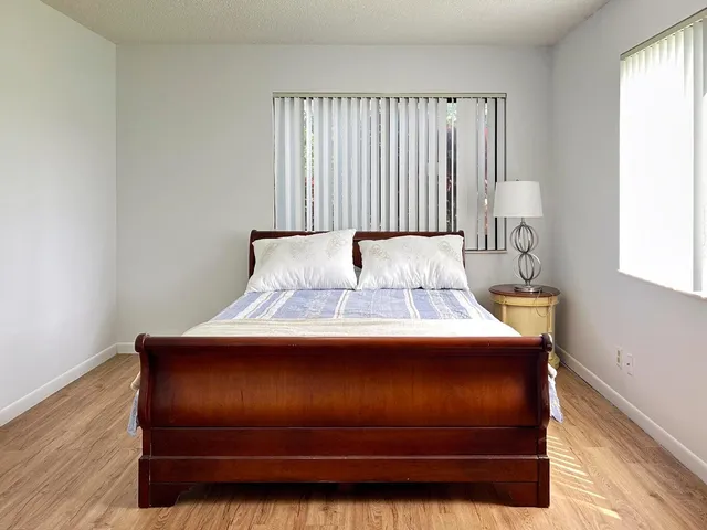 a bedroom with a bed and window