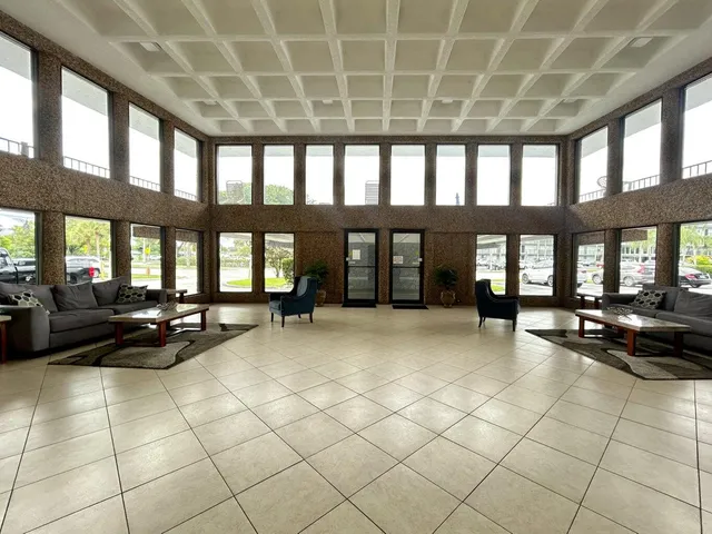 a lobby with furniture and floor to ceiling window