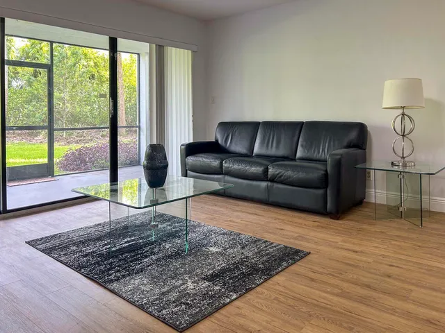 a living room with a couch and wooden floor