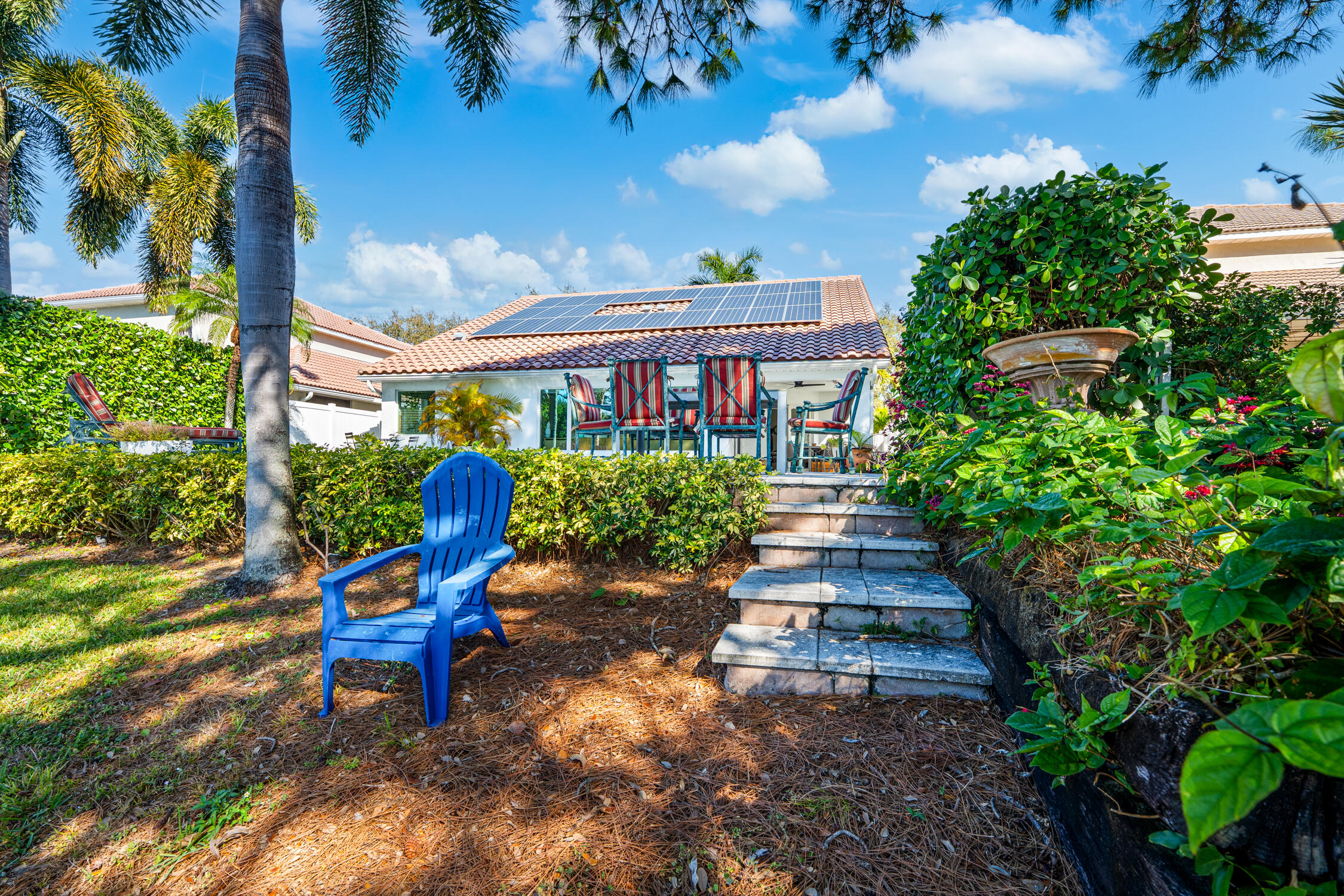 1084 Anchor Point Delray Beach, FL 33444 - Photo 19 of 25 a front view of a house with garden and sitting area