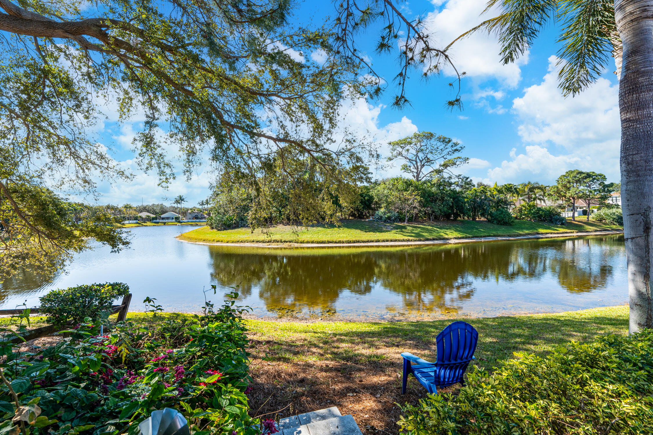 1084 Anchor Point Delray Beach, FL 33444 - Photo 21 of 25 a view of a lake with a house in the background