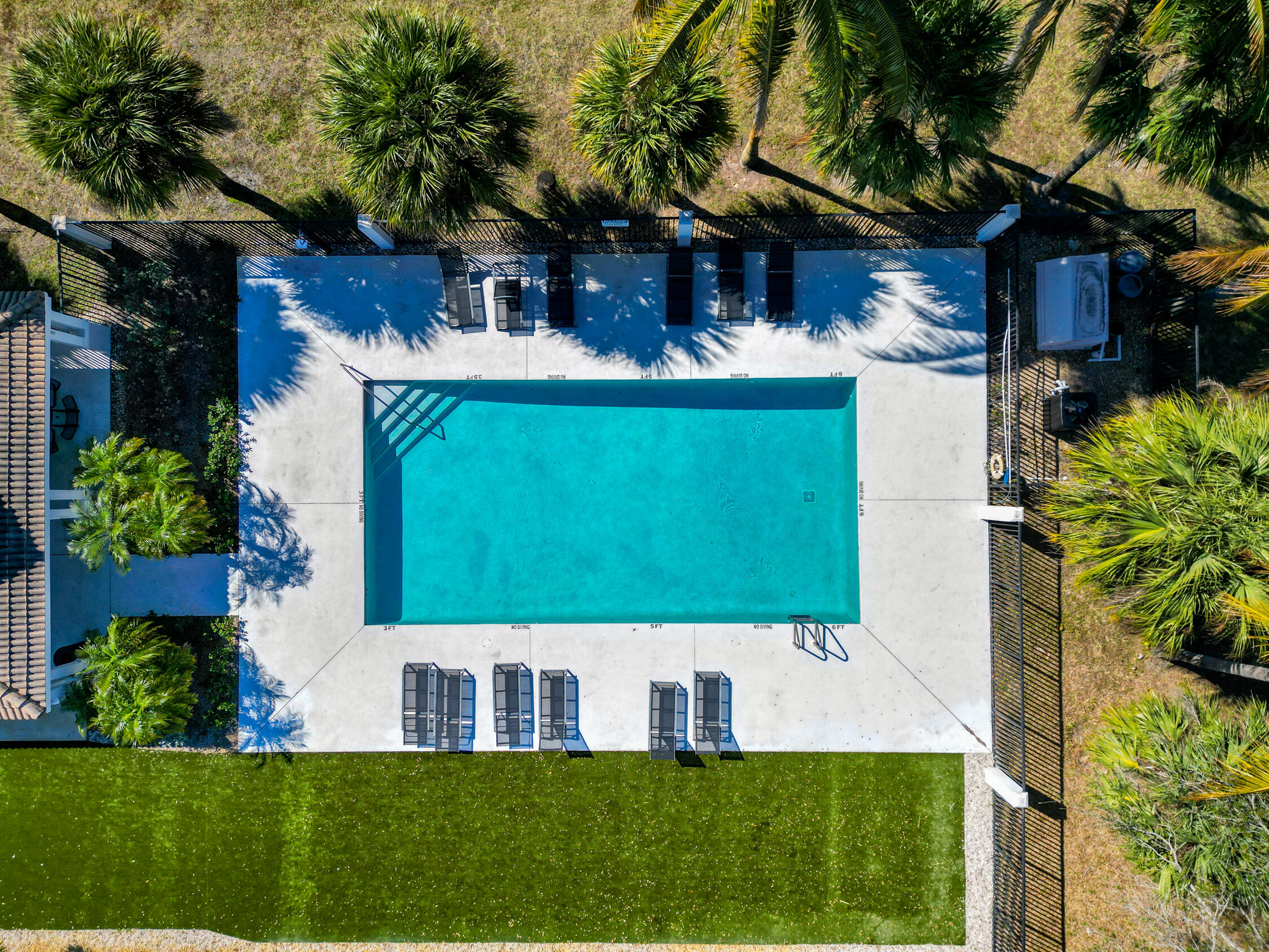 1084 Anchor Point Delray Beach, FL 33444 - Photo 23 of 25 a view of a white house with a big yard and potted plants
