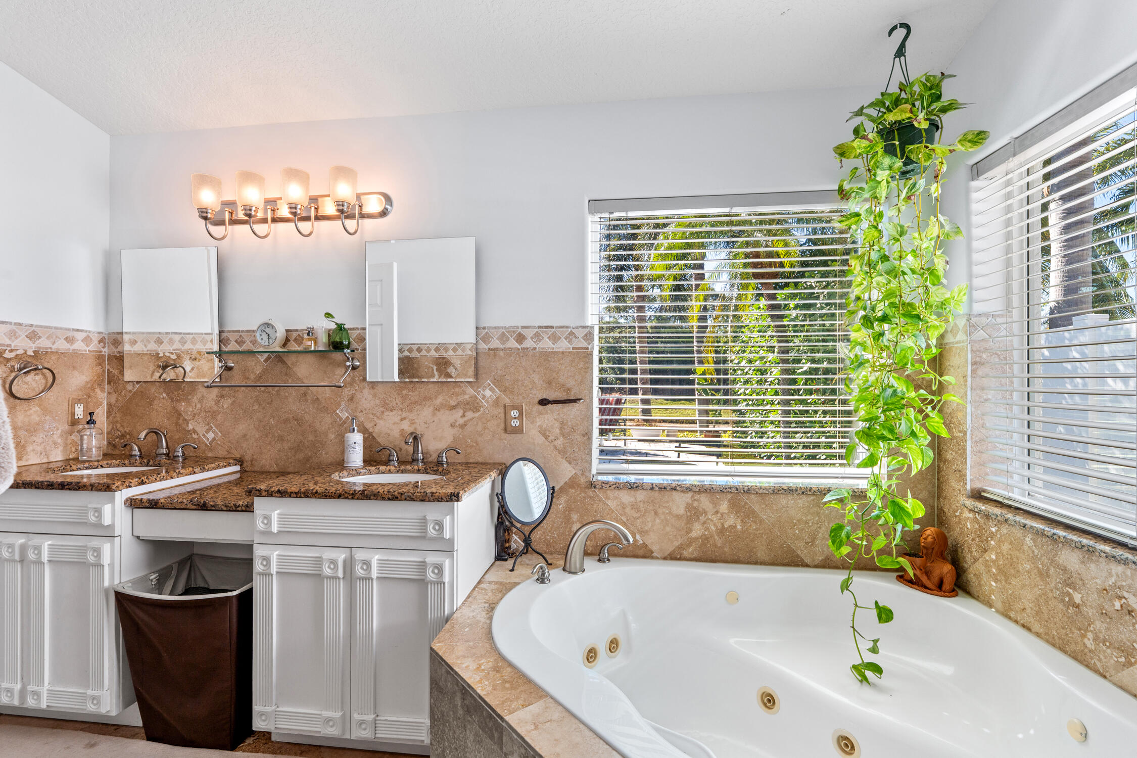 1084 Anchor Point Delray Beach, FL 33444 - Photo 8 of 25 a bathroom with a granite countertop sink a large mirror and a bathtub