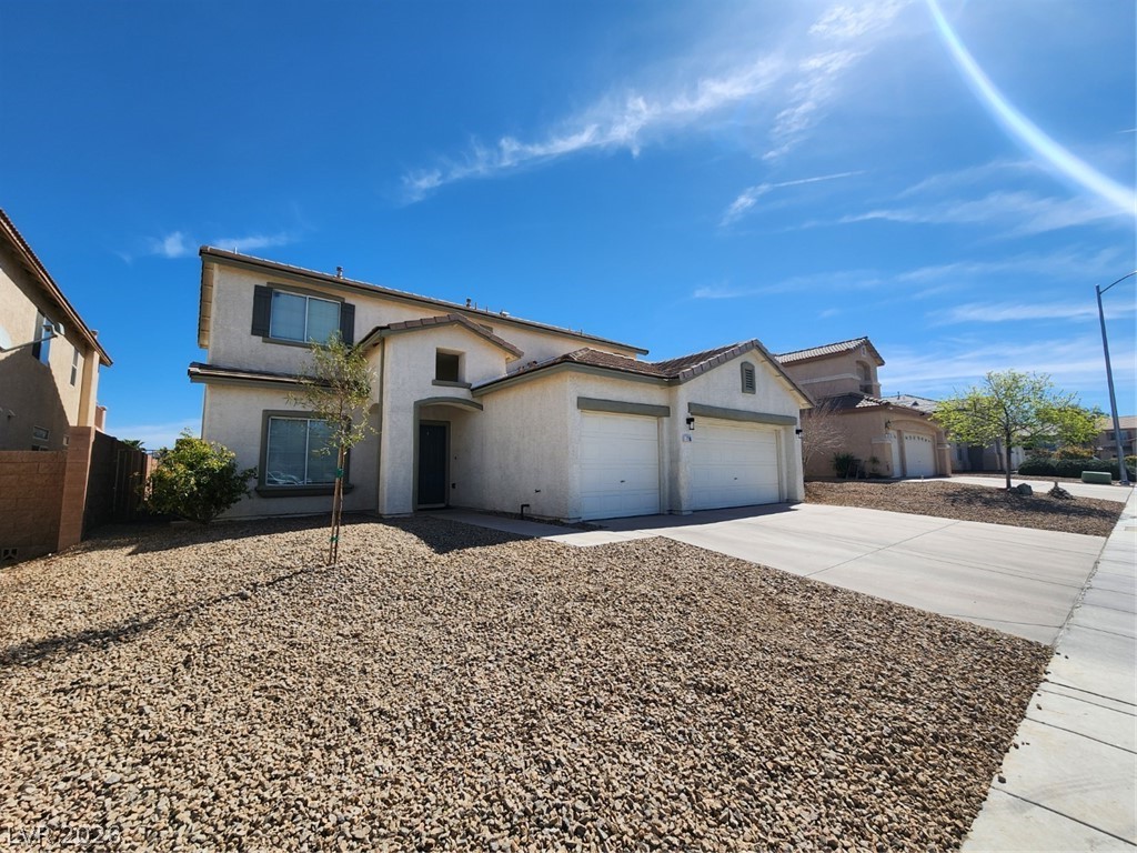 716 Sharon Hills Street Henderson, NV 89052 - Photo 2 of 66 View of front of home with concrete driveway, an attached garage, and stucco siding