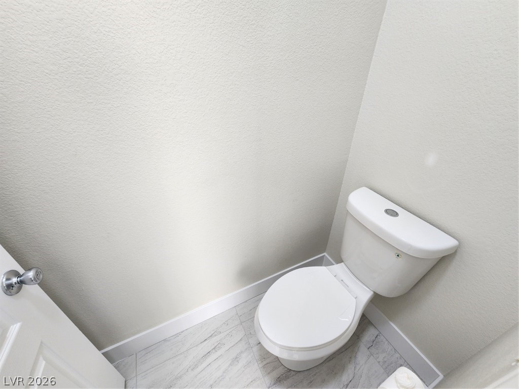 716 Sharon Hills Street Henderson, NV 89052 - Photo 20 of 66 Bathroom featuring baseboards and a textured wall