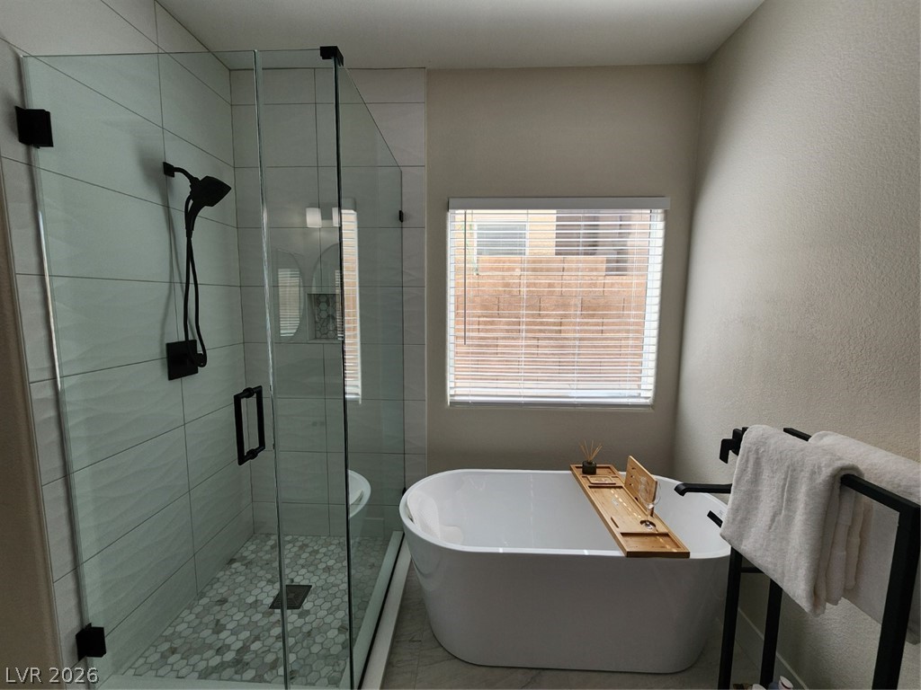 716 Sharon Hills Street Henderson, NV 89052 - Photo 21 of 66 Full bath with a stall shower, a soaking tub, and a textured wall