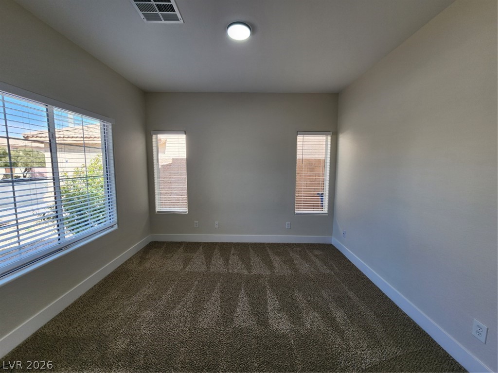 716 Sharon Hills Street Henderson, NV 89052 - Photo 22 of 66 Unfurnished room featuring baseboards and dark colored carpet