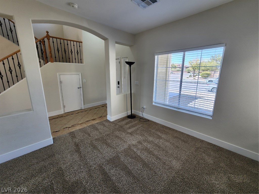 716 Sharon Hills Street Henderson, NV 89052 - Photo 25 of 66 Spare room with carpet floors and arched walkways