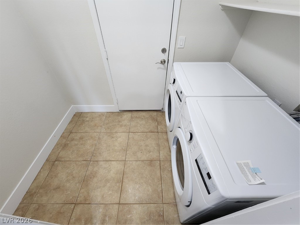 716 Sharon Hills Street Henderson, NV 89052 - Photo 27 of 66 Laundry area with light tile patterned flooring and washer and dryer