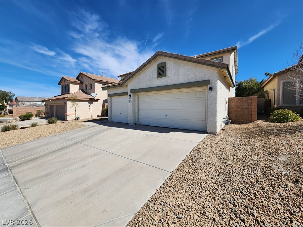 716 Sharon Hills Street Henderson, NV 89052 - Photo 3 of 66 View of front of house with an attached garage, concrete driveway, and stucco siding
