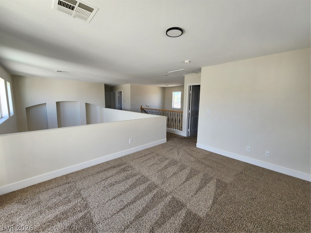 716 Sharon Hills Street Henderson, NV 89052 - Photo 31 of 66 Spare room featuring dark colored carpet and baseboards