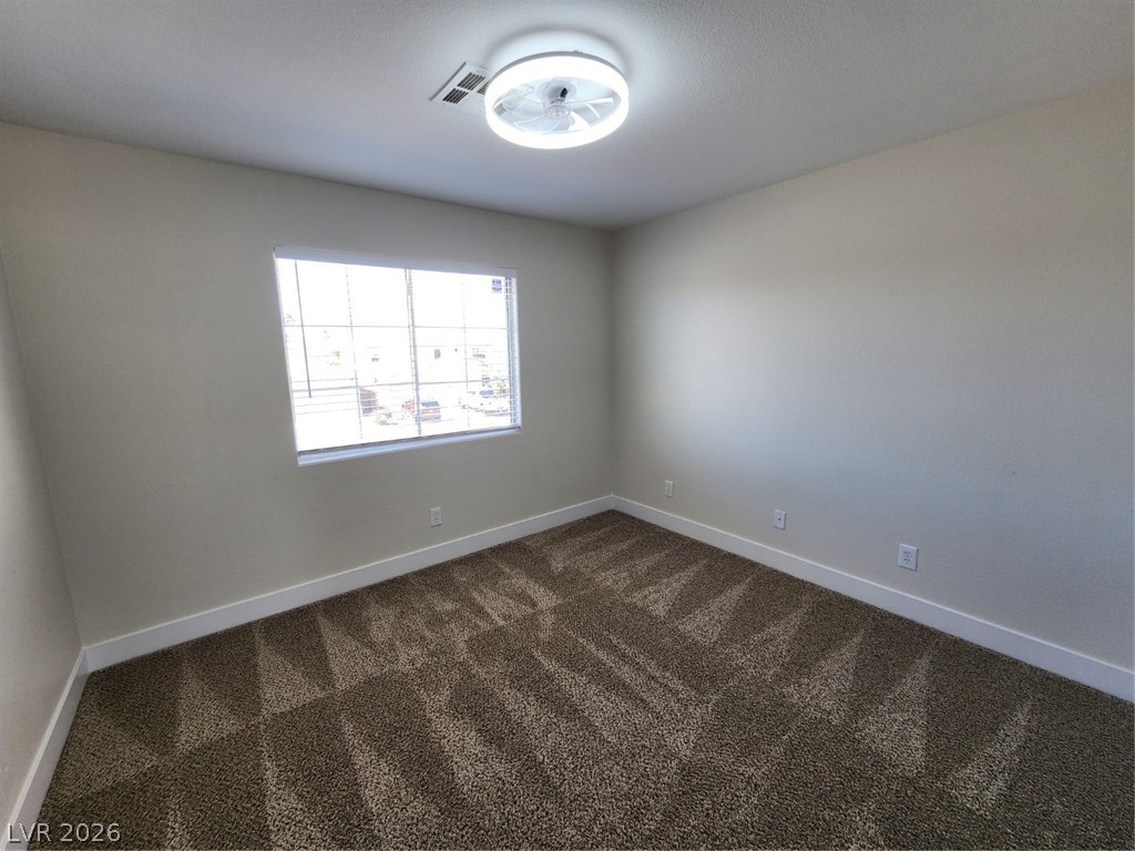716 Sharon Hills Street Henderson, NV 89052 - Photo 32 of 66 Unfurnished room with dark carpet and a ceiling fan