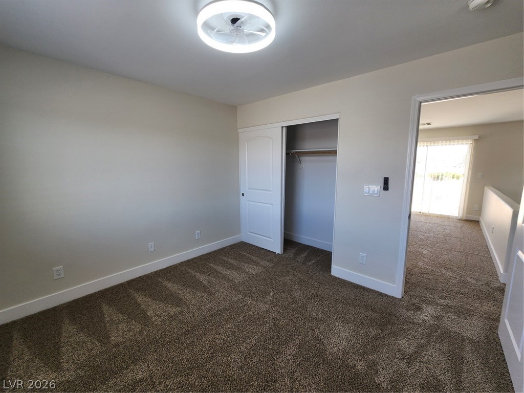716 Sharon Hills Street Henderson, NV 89052 - Photo 33 of 66 Unfurnished bedroom featuring dark carpet and a closet