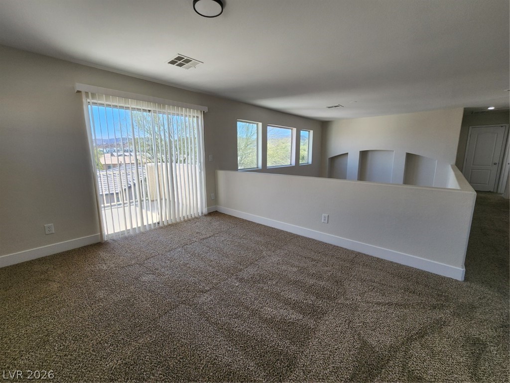 716 Sharon Hills Street Henderson, NV 89052 - Photo 35 of 66 Carpeted empty room with baseboards
