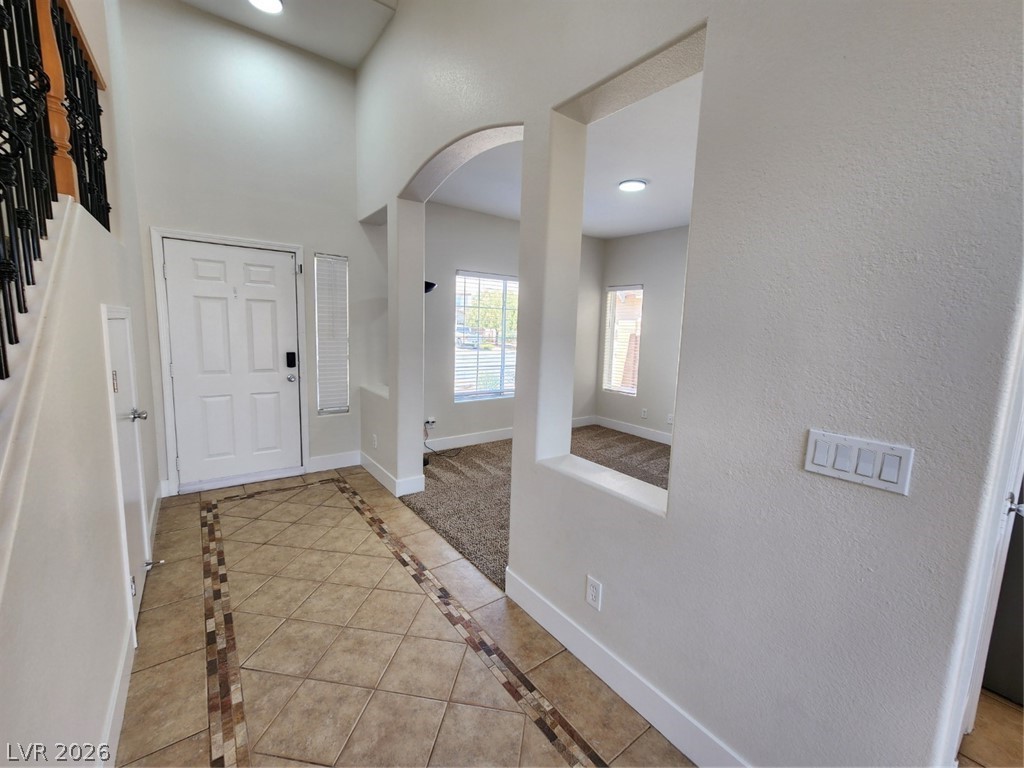 716 Sharon Hills Street Henderson, NV 89052 - Photo 4 of 66 Foyer entrance with arched walkways, recessed lighting, inlaid floor details, and light tile patterned floors