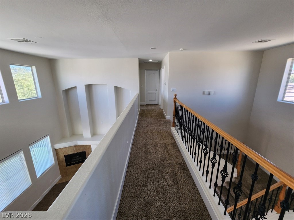 716 Sharon Hills Street Henderson, NV 89052 - Photo 42 of 66 Corridor featuring dark colored carpet and baseboards