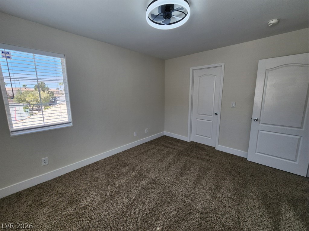 716 Sharon Hills Street Henderson, NV 89052 - Photo 46 of 66 Unfurnished bedroom with baseboards and dark carpet