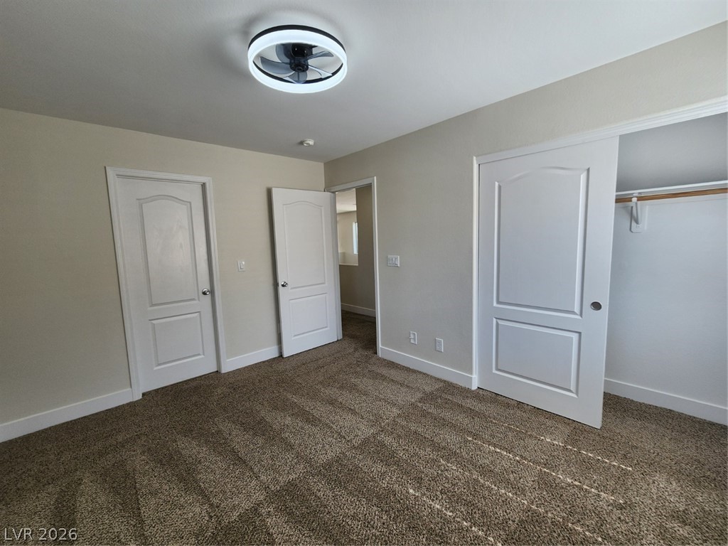 716 Sharon Hills Street Henderson, NV 89052 - Photo 47 of 66 Unfurnished bedroom with dark carpet and a closet