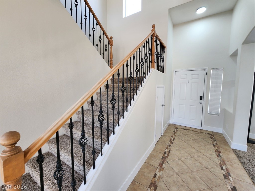 716 Sharon Hills Street Henderson, NV 89052 - Photo 5 of 66 Foyer featuring inlaid floor details, a high ceiling, and light tile patterned floors
