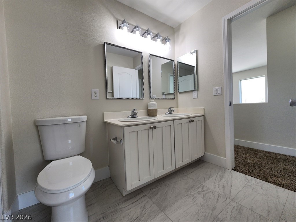 716 Sharon Hills Street Henderson, NV 89052 - Photo 49 of 66 Bathroom featuring double vanity and light marble finish flooring