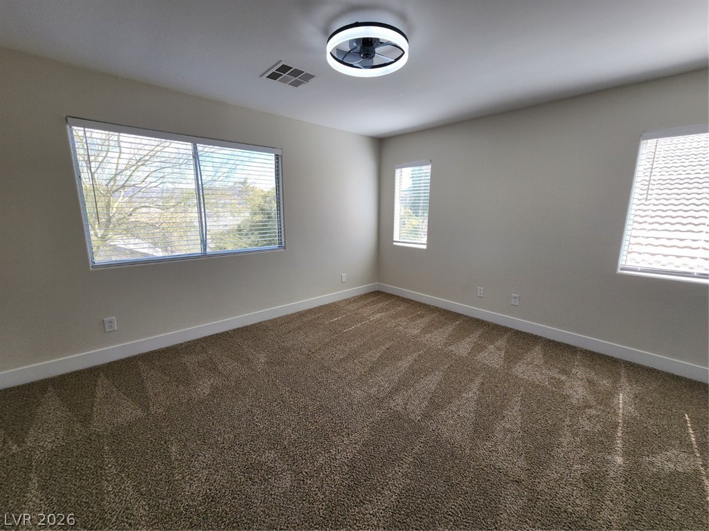 716 Sharon Hills Street Henderson, NV 89052 - Photo 51 of 66 Unfurnished room featuring dark colored carpet and baseboards