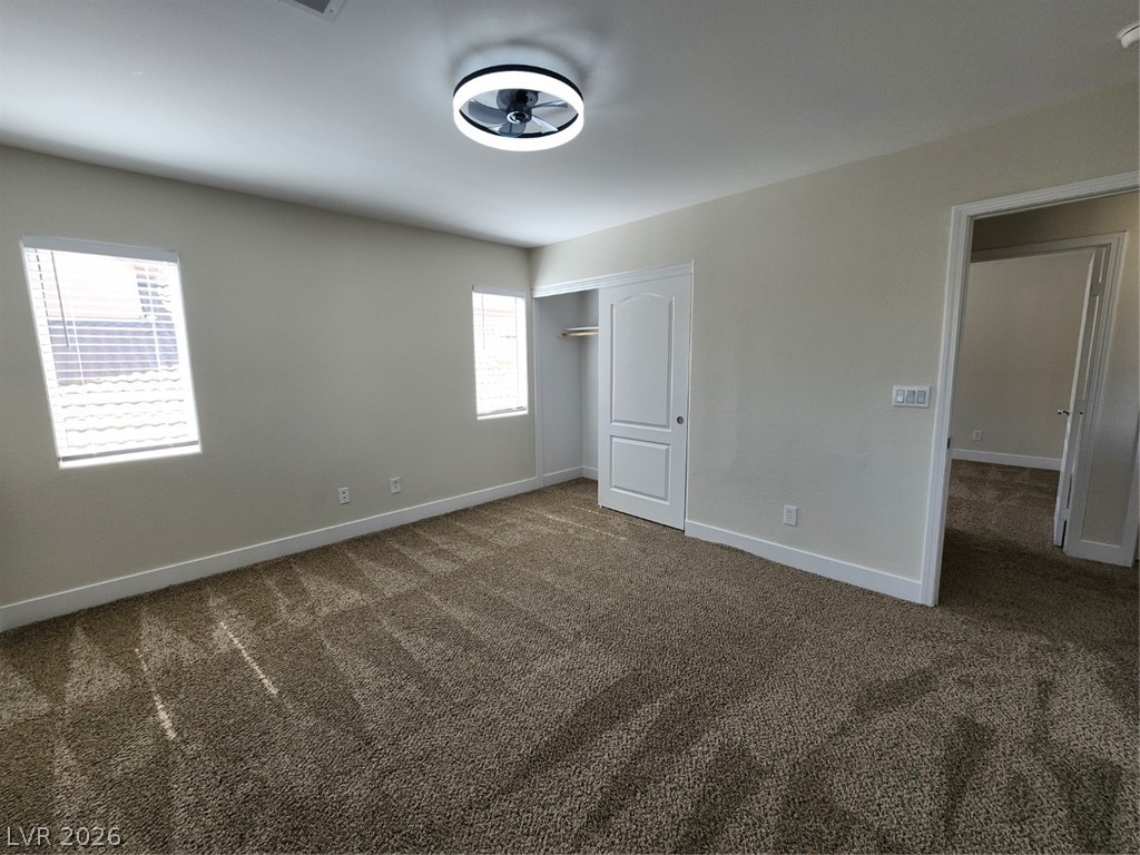 716 Sharon Hills Street Henderson, NV 89052 - Photo 52 of 66 Unfurnished bedroom featuring dark carpet and a closet