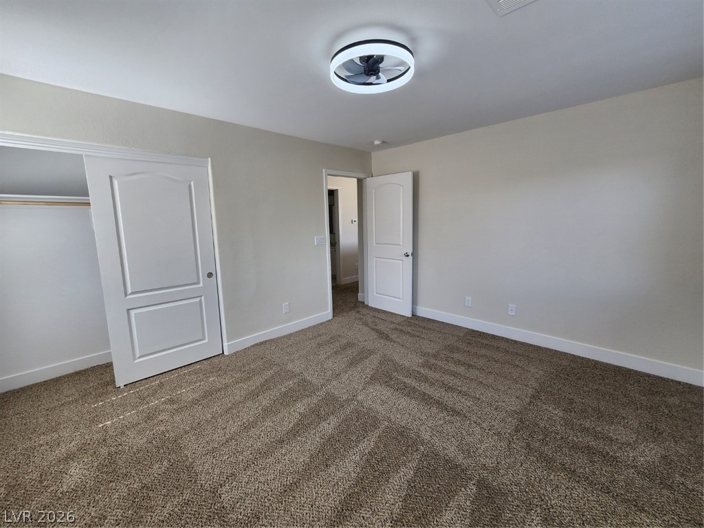 716 Sharon Hills Street Henderson, NV 89052 - Photo 53 of 66 Unfurnished bedroom with dark colored carpet and a closet