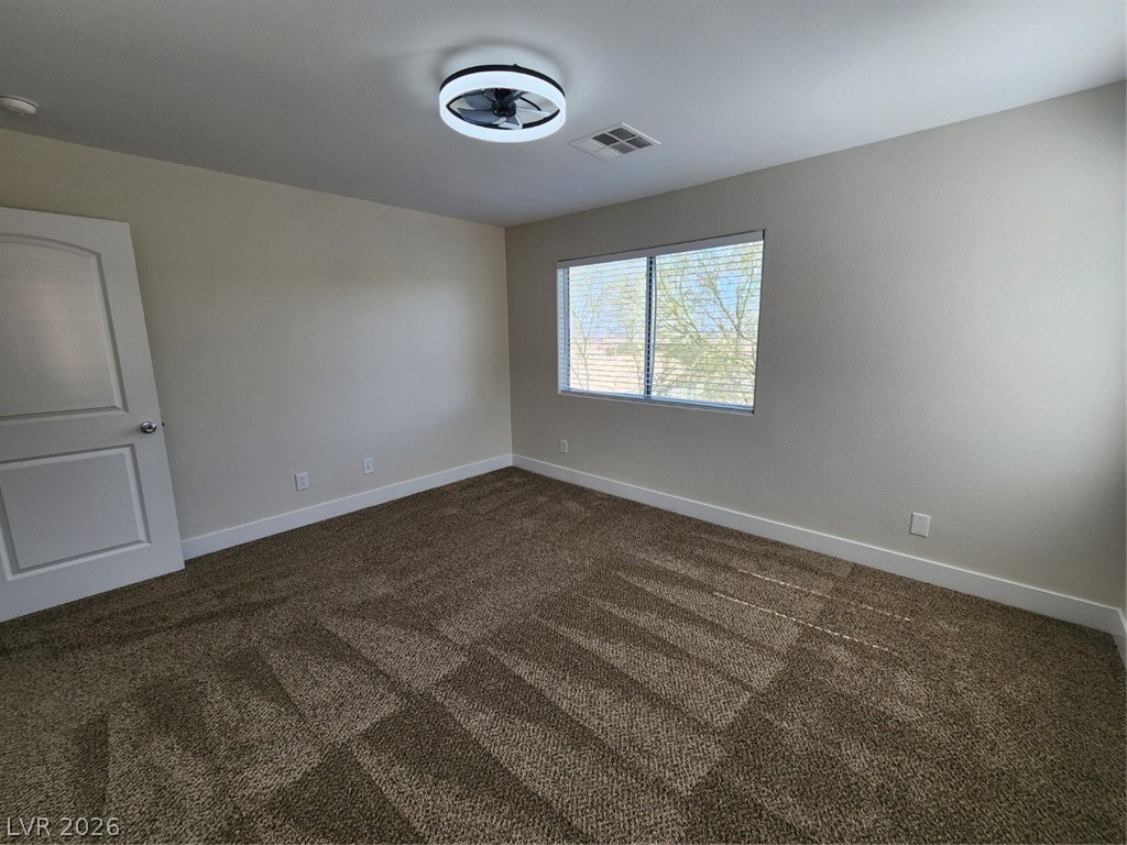 716 Sharon Hills Street Henderson, NV 89052 - Photo 54 of 66 Spare room with dark colored carpet and a smoke detector