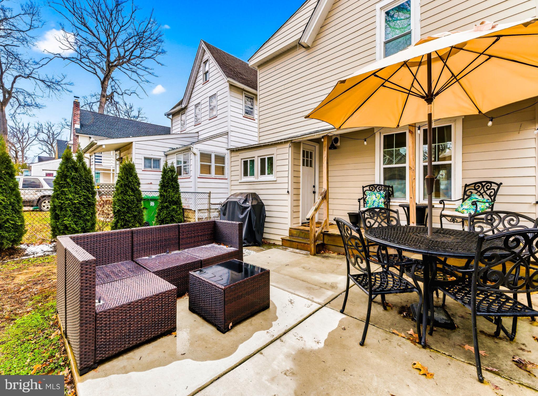 321 West Avenue Pitman, NJ 08071 - Photo 23 of 24 a view of a patio with table and chairs under an umbrella