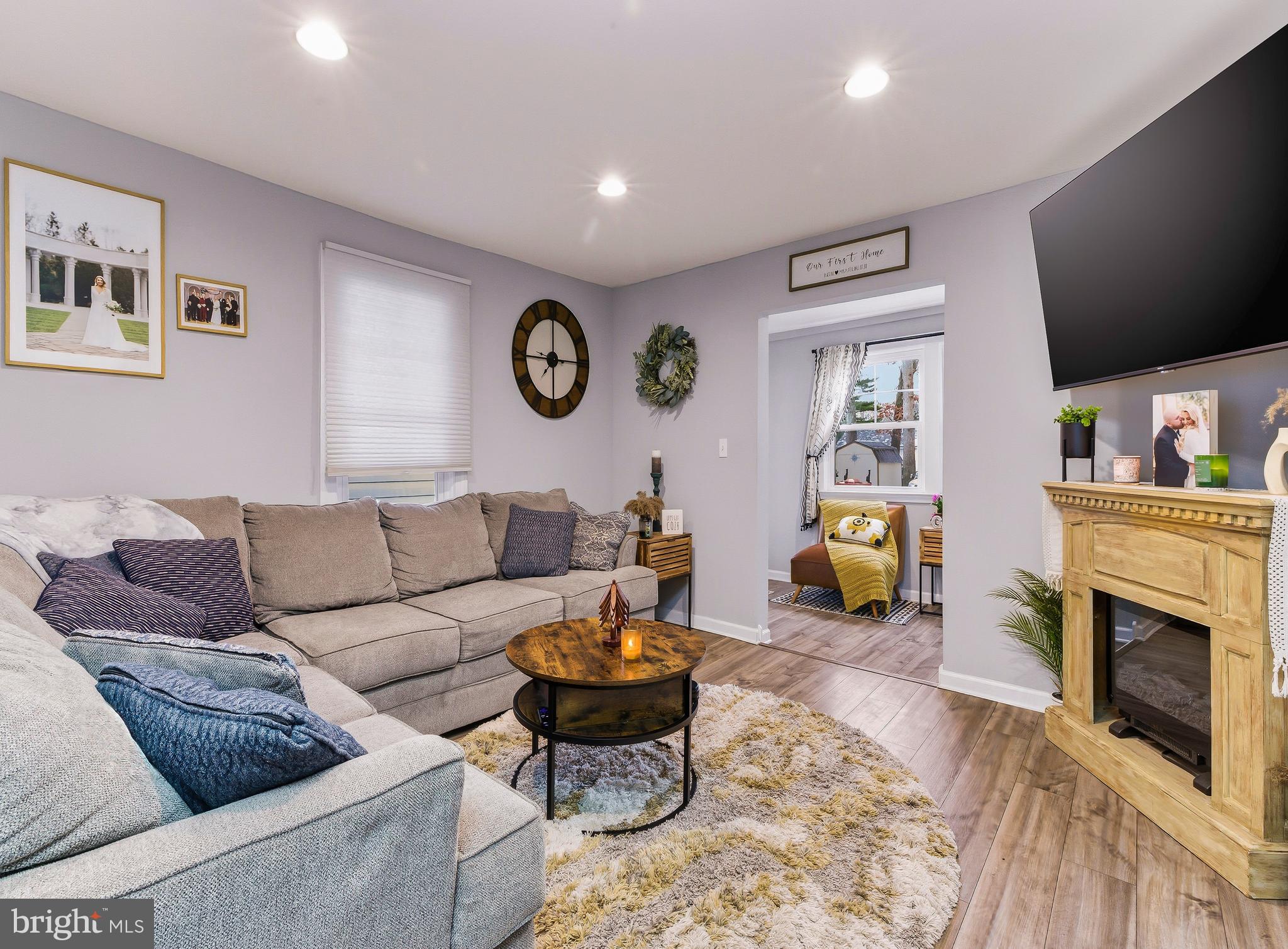 321 West Avenue Pitman, NJ 08071 - Photo 6 of 24 a living room with furniture a fireplace and a flat screen tv