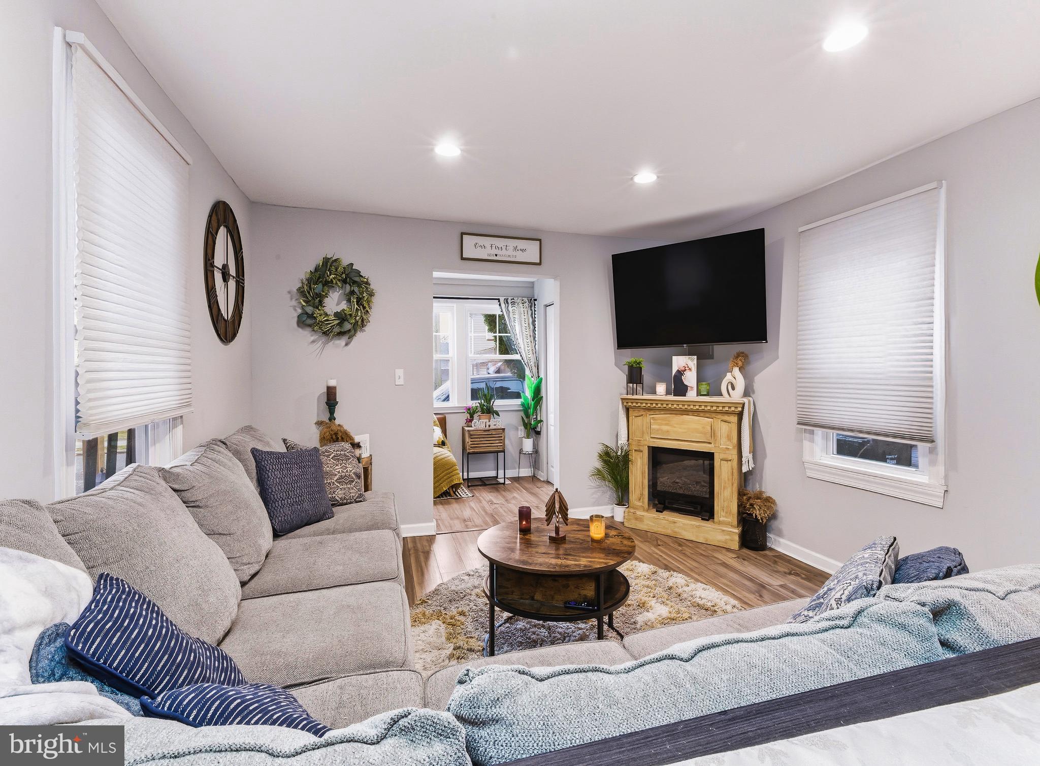 321 West Avenue Pitman, NJ 08071 - Photo 7 of 24 a living room with furniture a fireplace and a flat screen tv