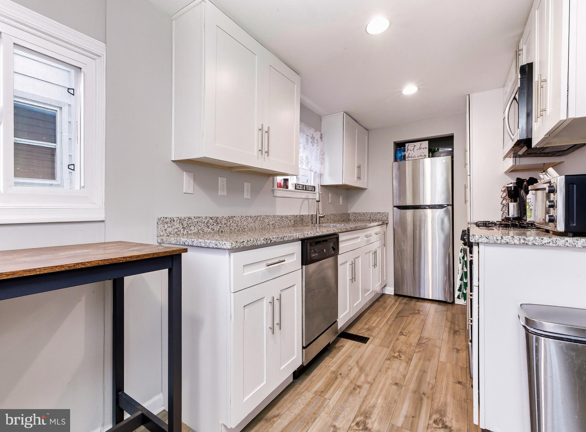 321 West Avenue Pitman, NJ 08071 - Photo 8 of 24 a kitchen with white cabinets and stainless steel appliances