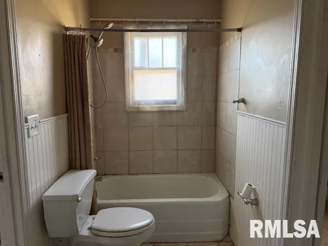 a bathroom with a toilet bathtub and shower
