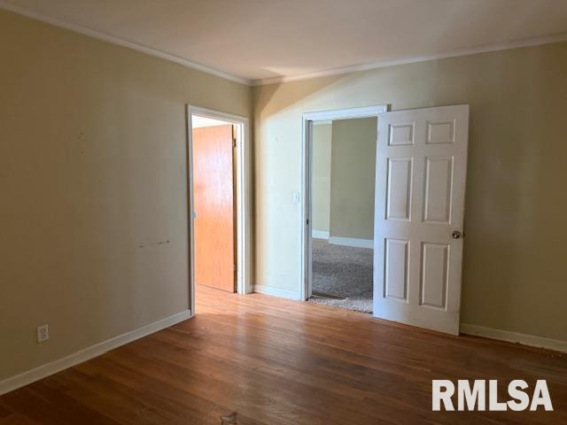 1112 McHaney Road Harrisburg, IL 62946 - Photo 18 of 27 an empty room with wooden floor and closet area