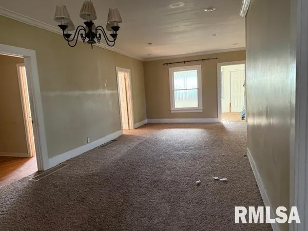 an empty room with windows and entrance