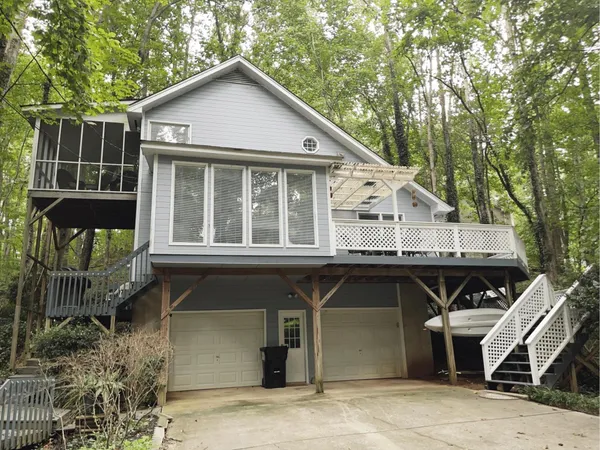 a view of a wooden chairs and table in the balcony