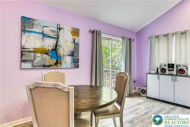 a dining room with furniture and window